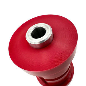 Close up of red polyurethane 75D subframe bushings for BMW E30. Made in USA by AKG Motorsport.