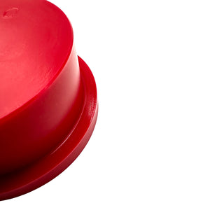 Close up of red polyurethane 75D rear subframe bushings for BMW E90, E92, E82. Made in USA by AKG Motorsport.