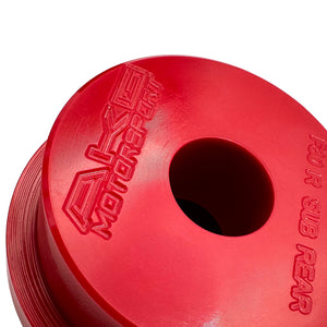 Close up of red polyurethane 75D rear subframe bushings for BMW F30, F32, F22. Made in USA by AKG Motorsport.
